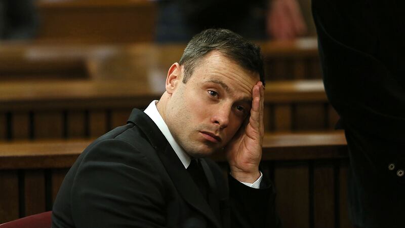 FILE - Oscar Pistorius gestures, at the end of the fourth day of sentencing proceedings in the...