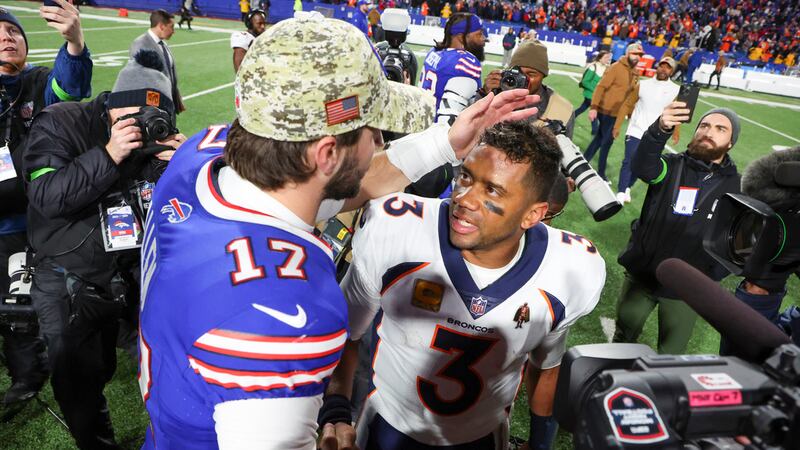 Buffalo Bills quarterback Josh Allen (17) greets Denver Broncos quarterback Russell Wilson (3)...