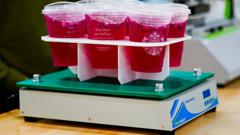 FILE - Plastic cups for cold drinks undergo a shake test on an orbital shaker at the Tryer...