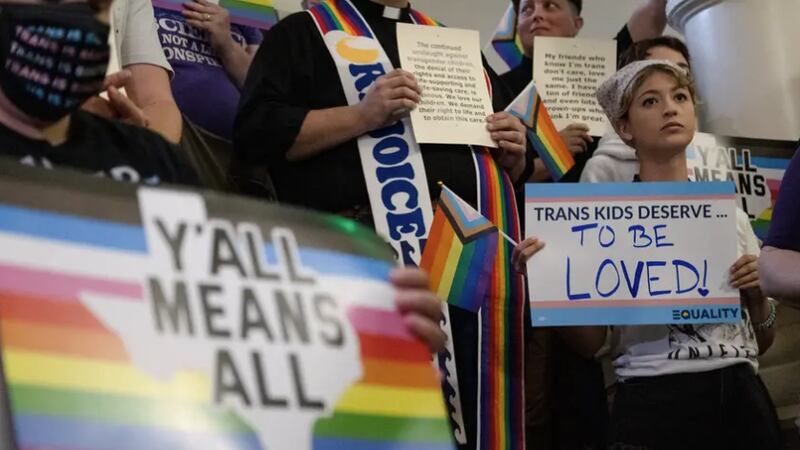 People gathered on the stairs across from the House floor to protest against Senate Bill 14,...