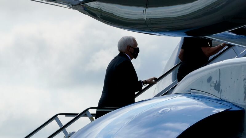 Vice President Mike Pence boards Air Force Two after attending a ceremony marking the 19th...