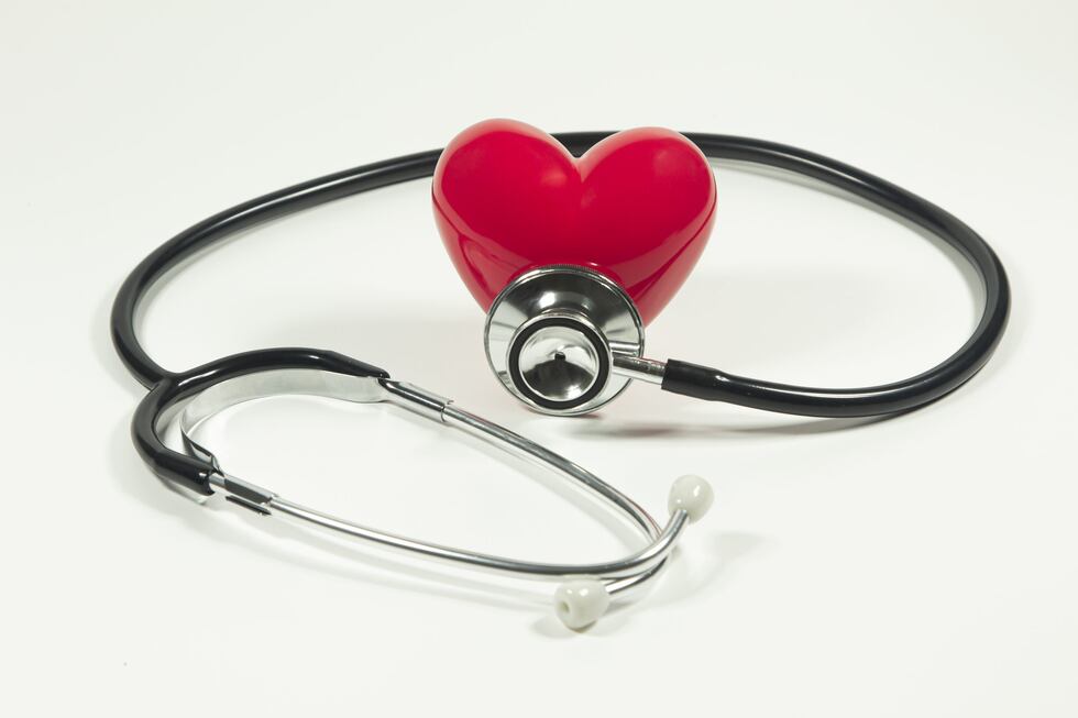Red heart and a stethoscope on isolated white background.