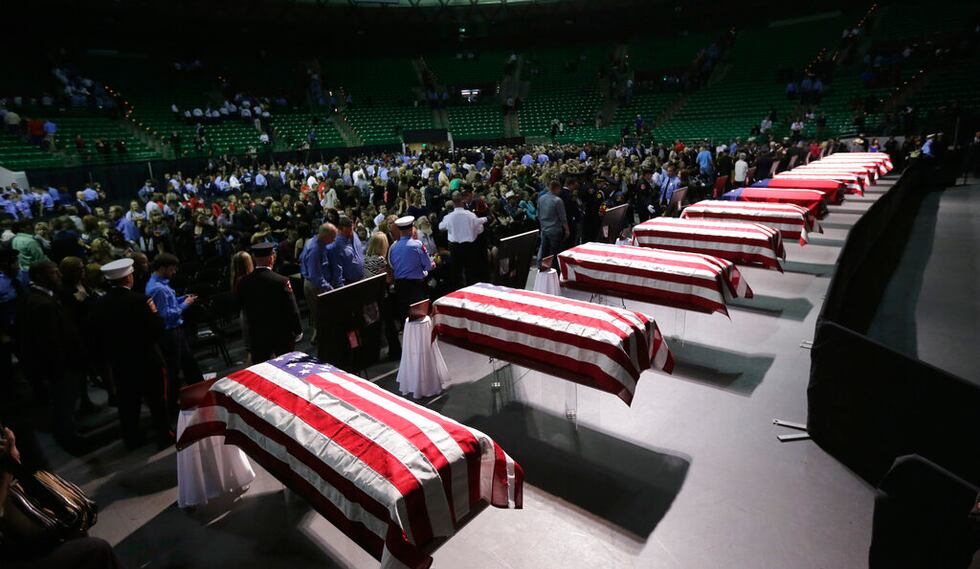 Family members attend a memorial for firefighters killed at the fertilizer plant explosion in...