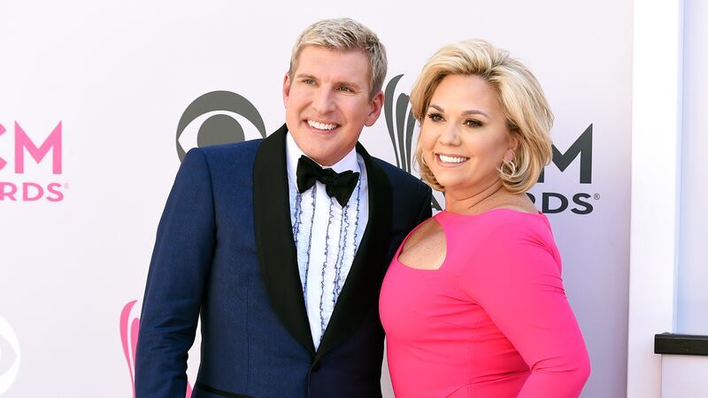 Todd Chrisley, left, and his wife, Julie Chrisley, pose for photos at the 52nd annual Academy...
