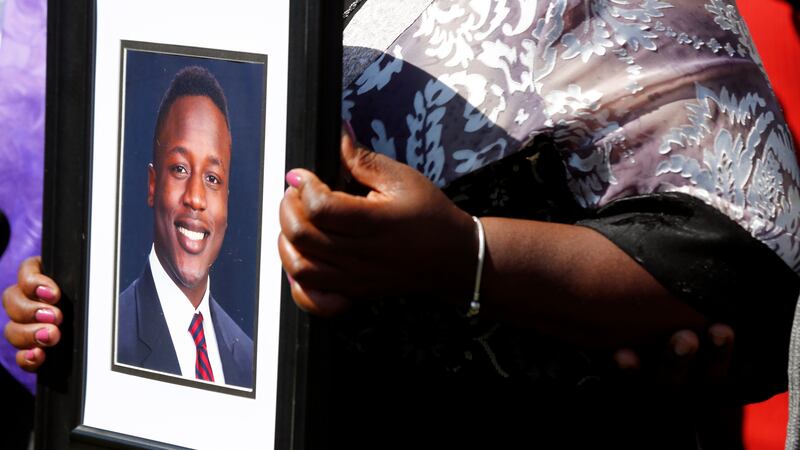 FILE - Caroline Ouko, mother of Irvo Otieno, holds a portrait of her son at the Dinwiddie...